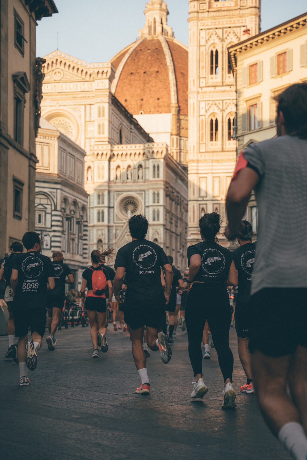 Runners of Florence running toward the Duomo at sunrise