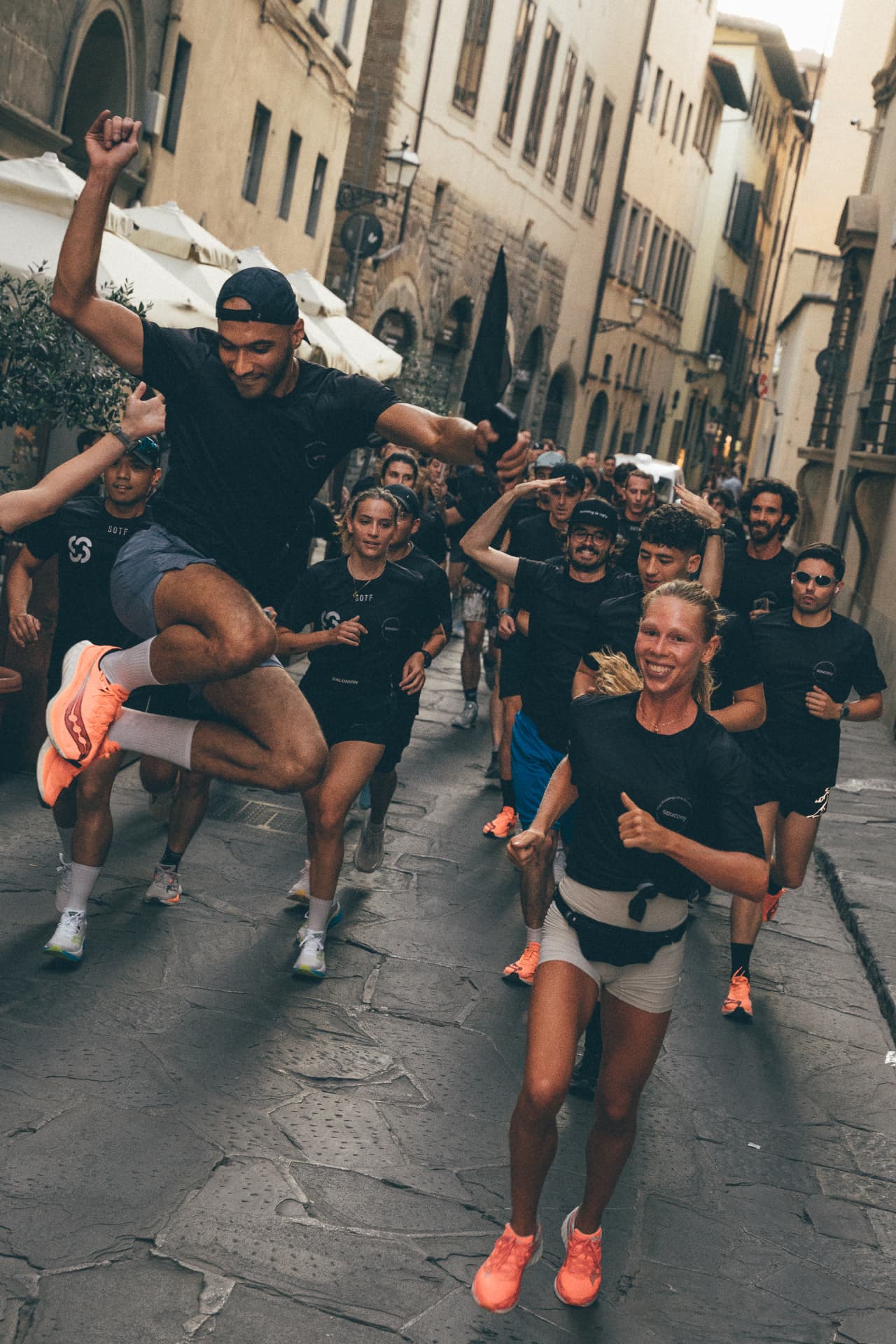Large group running together through historic Florence